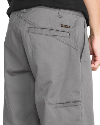 Gray pants with a visible brand logo on a plain background