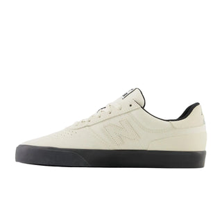 White sneaker with black sole on a white background
