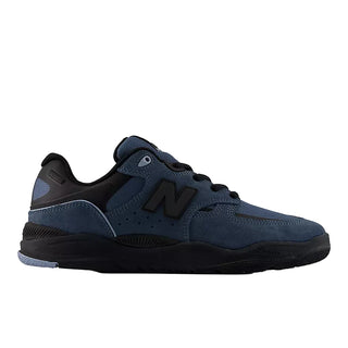 A New Balance athletic shoe in navy blue suede and synthetic mesh with black accents, including the 'N' logo, laces, and midsole, shown from a side profile on a white background.