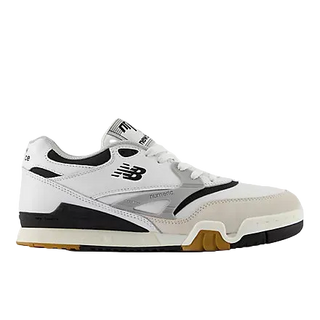 A New Balance sneaker in white, black, and beige, featuring a white leather upper, black accents, a beige suede toe cap, and a gum outsole, shown against a light gray background.