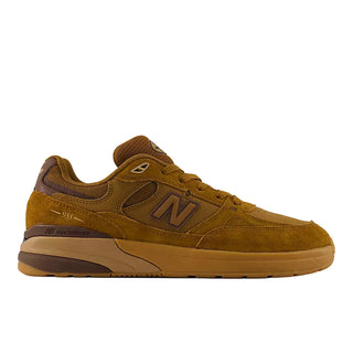 A New Balance sneaker in a warm brown and tan colorway, featuring suede and mesh panels, a brown 'N' logo, and a thick tan midsole on a white background.
